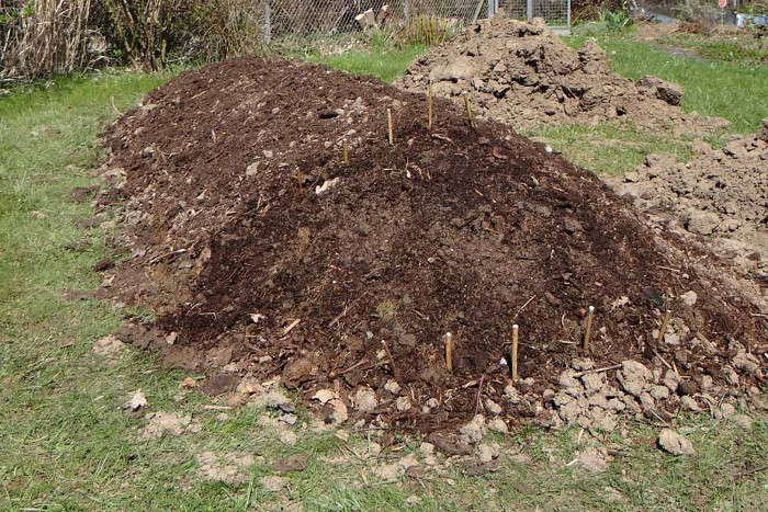Sechster Schritt beim Bau eines Hügelbeets: Eine Schicht aus Kompost und Erde